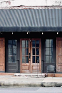 Wide shot of a storefront with custom-designed awnings in blue and white.