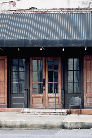 A dark grey fixed awning providing shade over a business storefront entrance.