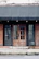 A modern storefront with a sleek, dark-colored awning displaying the business name.