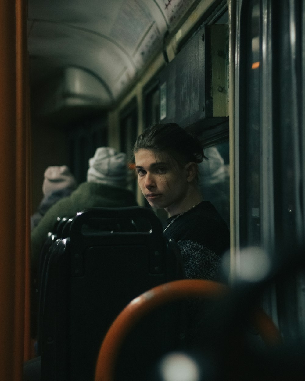 a woman sitting on a train looking out the window