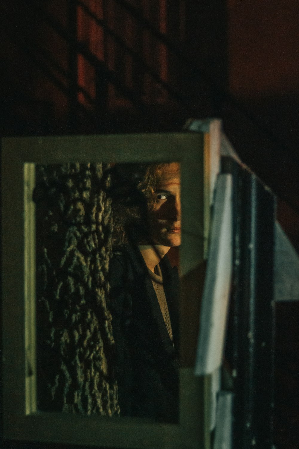 a man in a suit and tie standing in front of a mirror