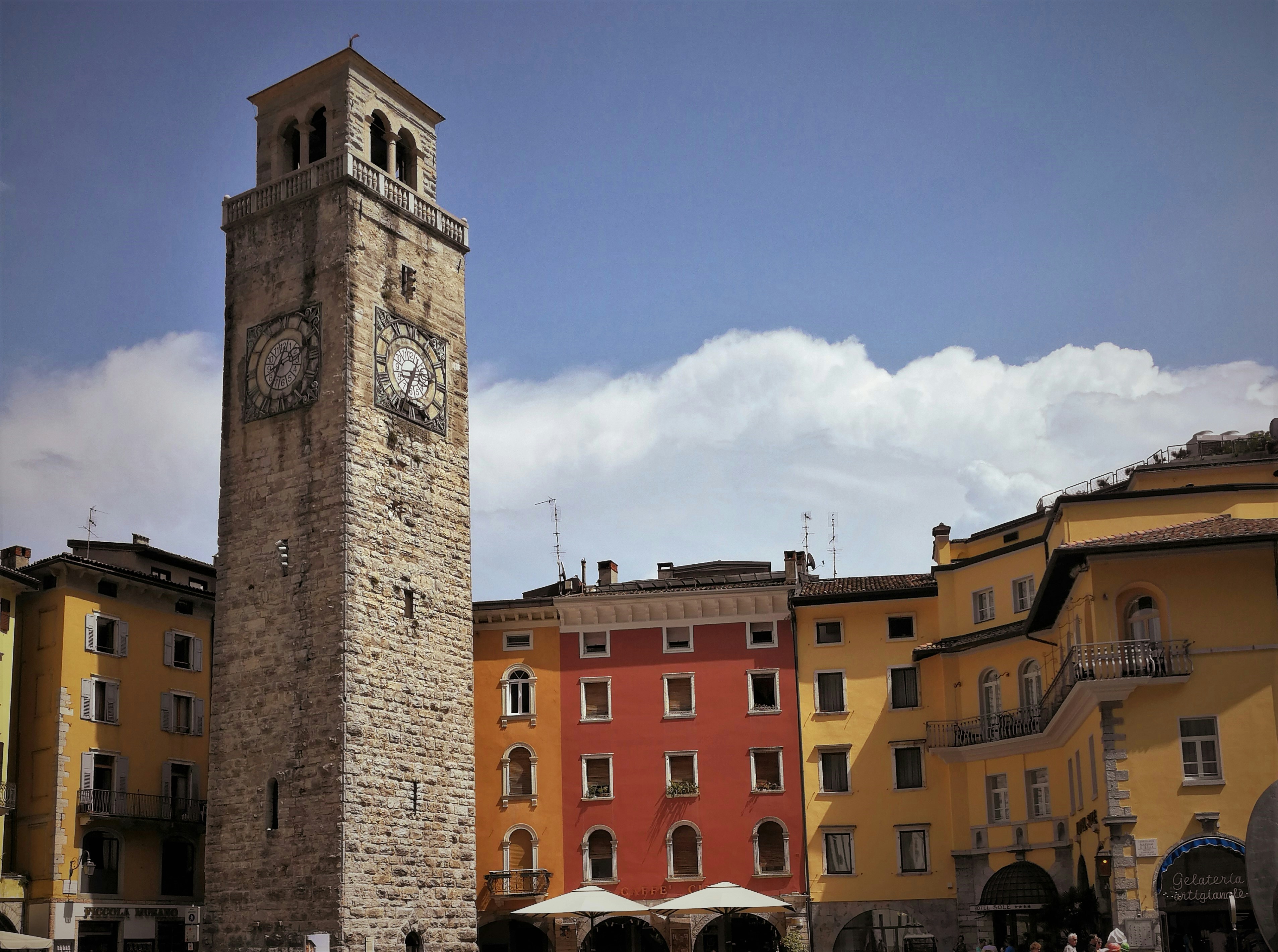 a tall clock tower sitting in the middle of a city in Civita