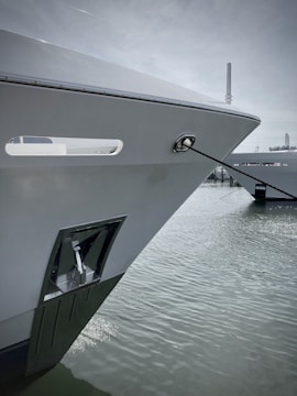 A close-up of a modern ship navigating through calm waters.