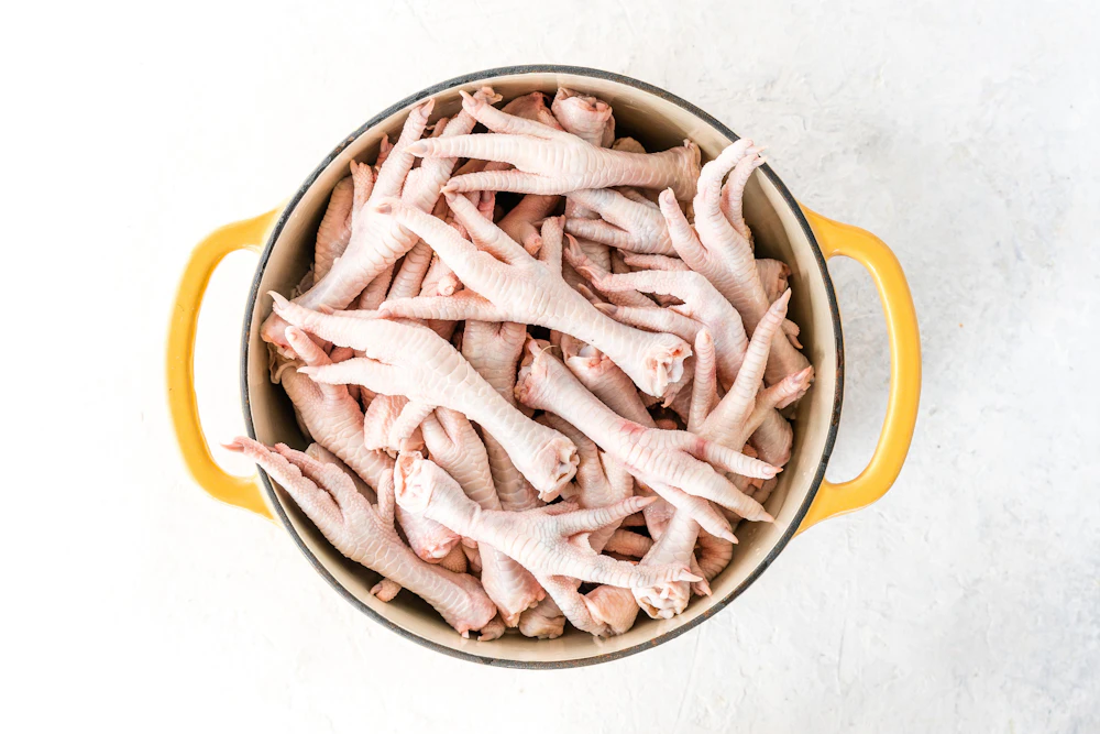 Cleaned raw chicken feet in a pot