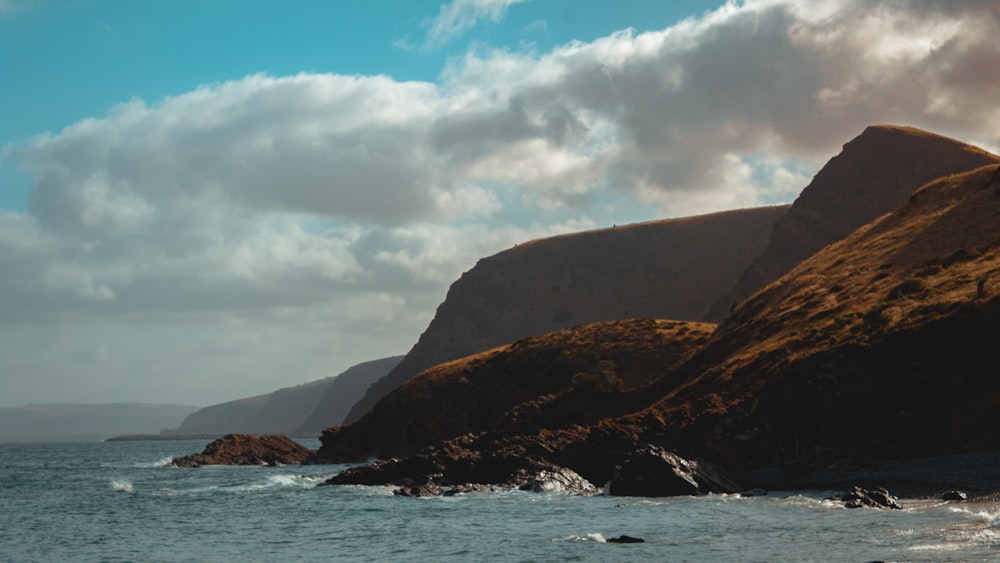 a body of water with a mountain in the background