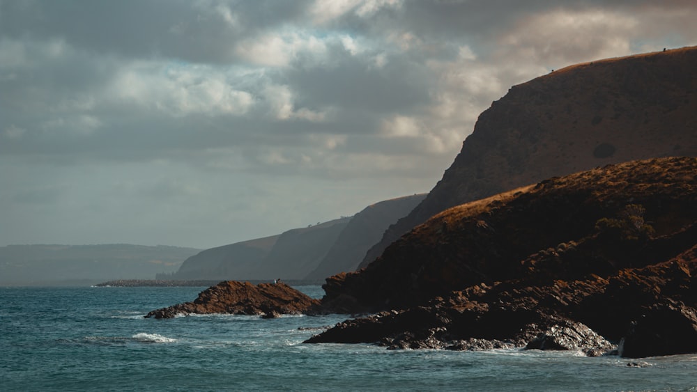 a body of water with a mountain in the background