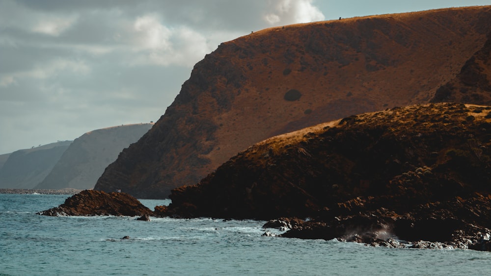 a body of water with a mountain in the background