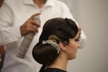 a woman getting her hair done by a hair stylist