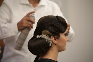 a woman getting her hair done by a hair stylist