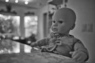 A beautifully lit display of various silicone dolls posed elegantly against a minimalist backdrop.