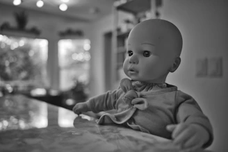 A beautifully lit display of various silicone dolls posed elegantly against a minimalist backdrop.