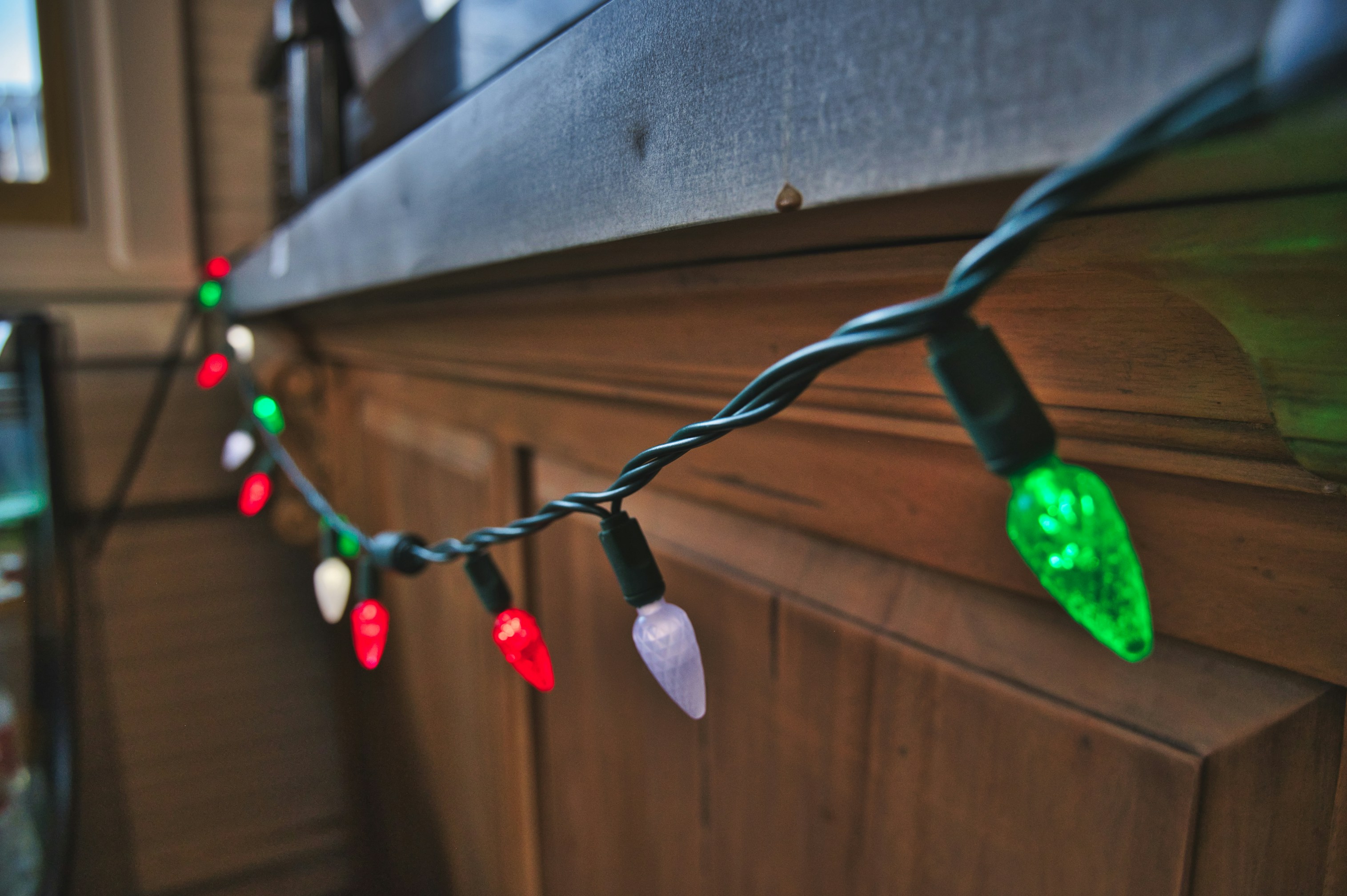 a string of christmas lights hanging on a wall