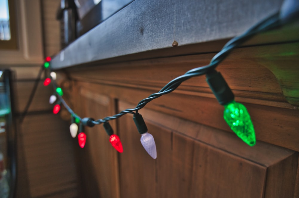 a string of christmas lights hanging on a wall