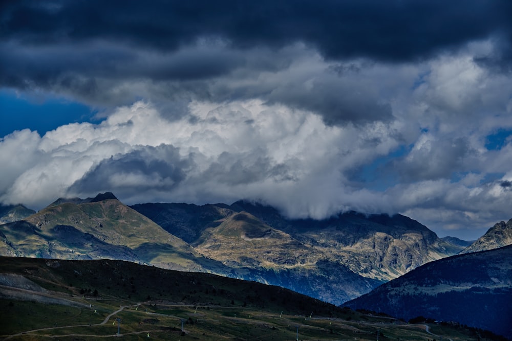 a view of a mountain range under a cloudy sky