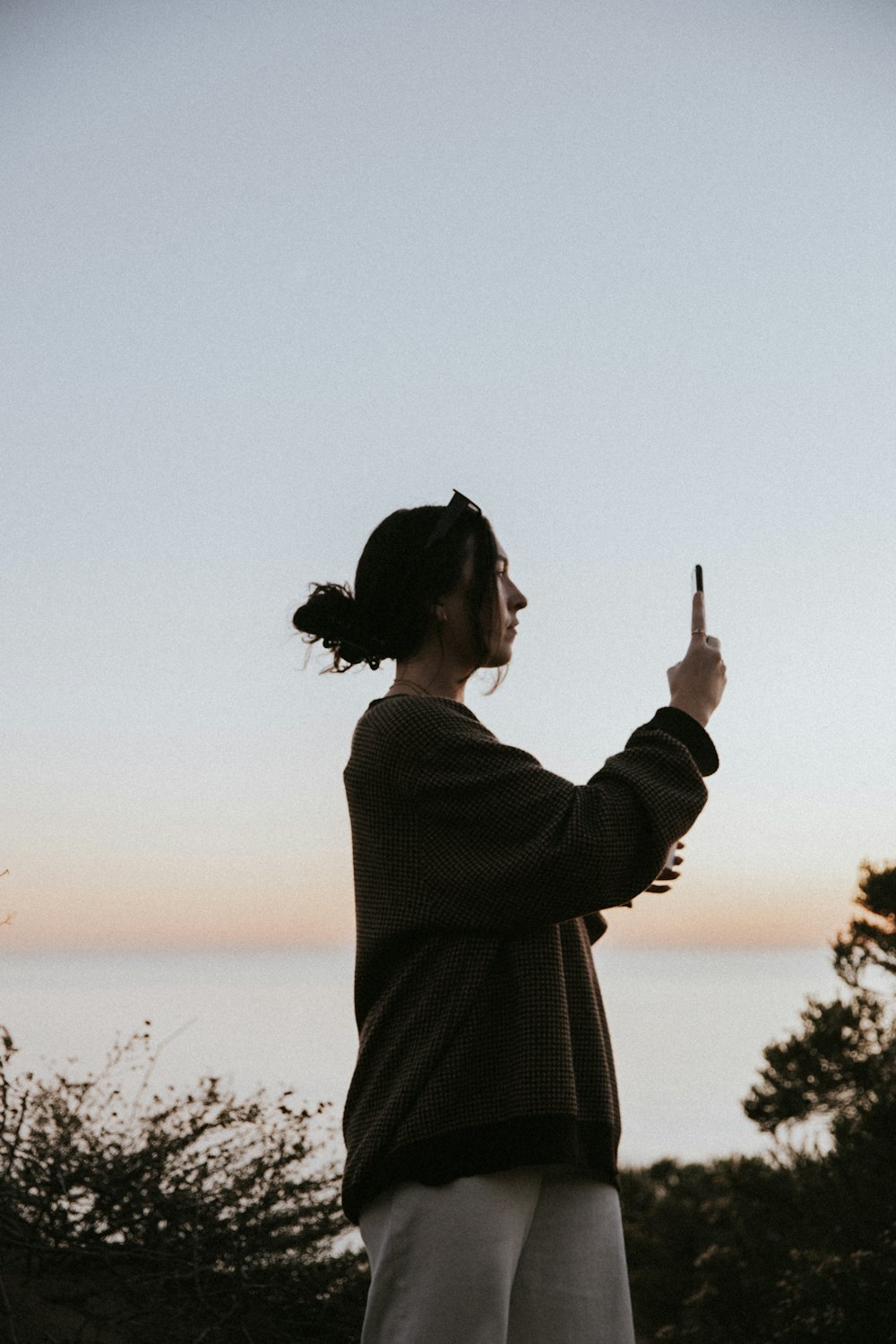 a woman taking a picture with her cell phone