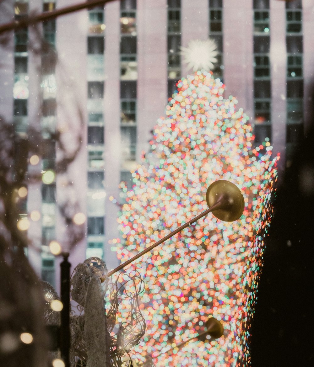 a christmas tree is seen through a window