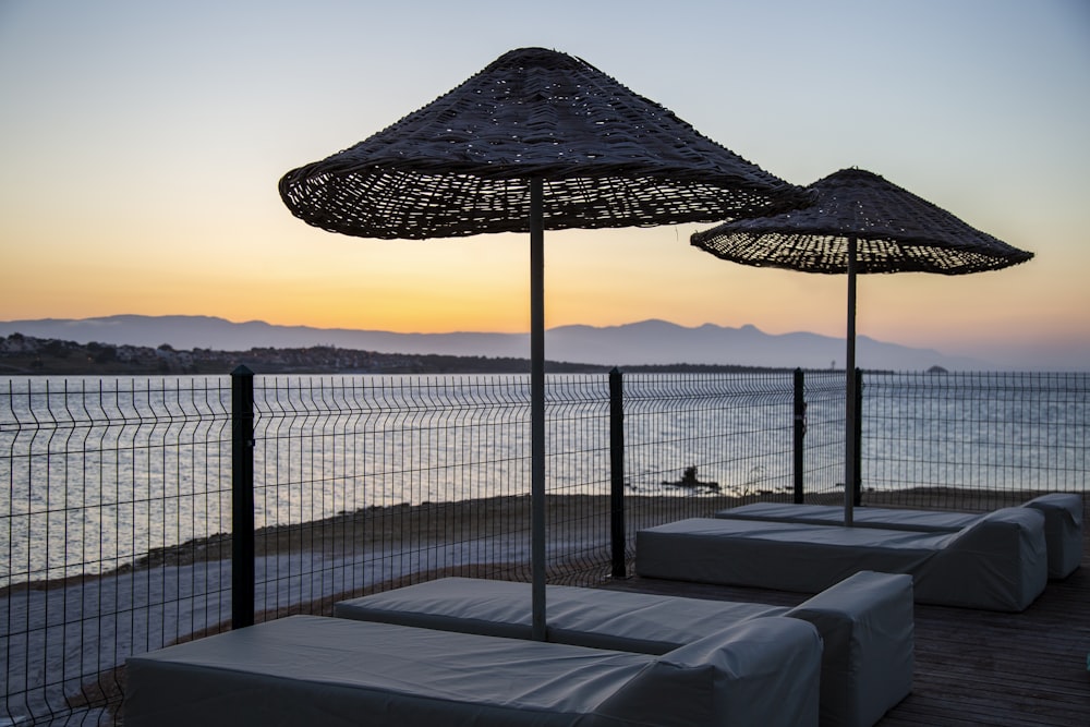 a couple of umbrellas sitting on top of a wooden deck