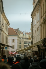 Historic city street with old buildings and pedestrians exploring the area.