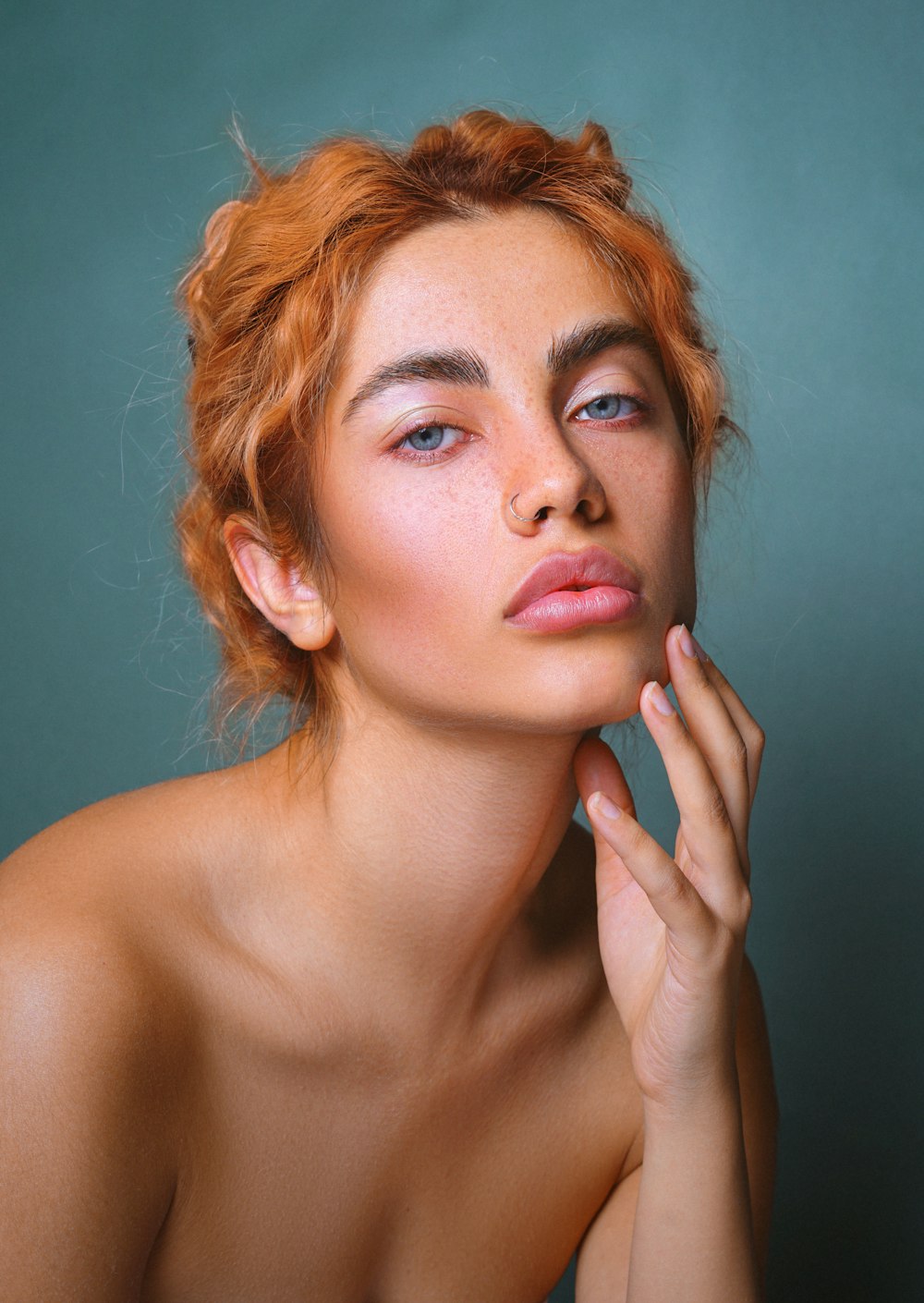 a woman with freckled hair is posing for a picture