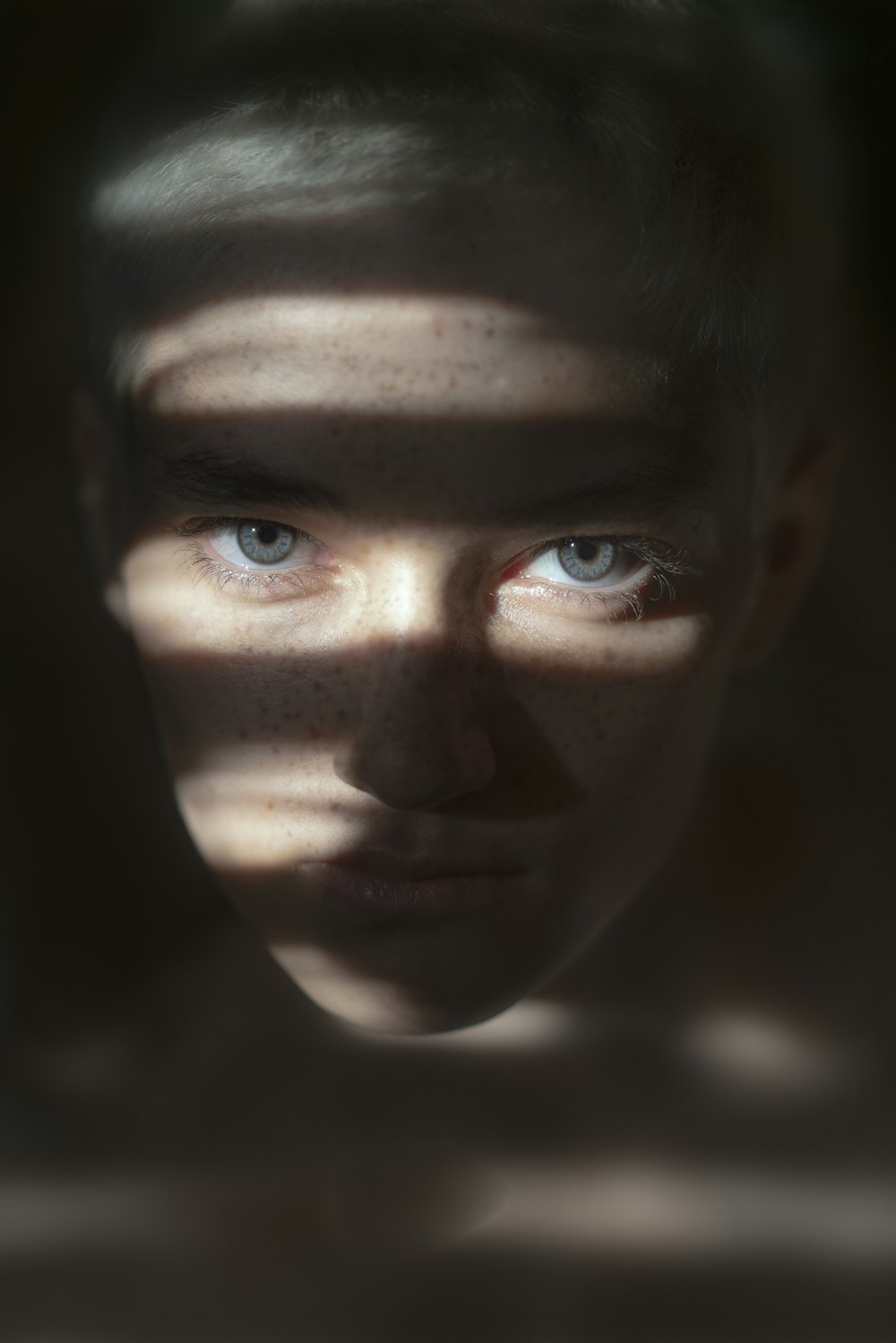 a woman's face is shown through a shadow