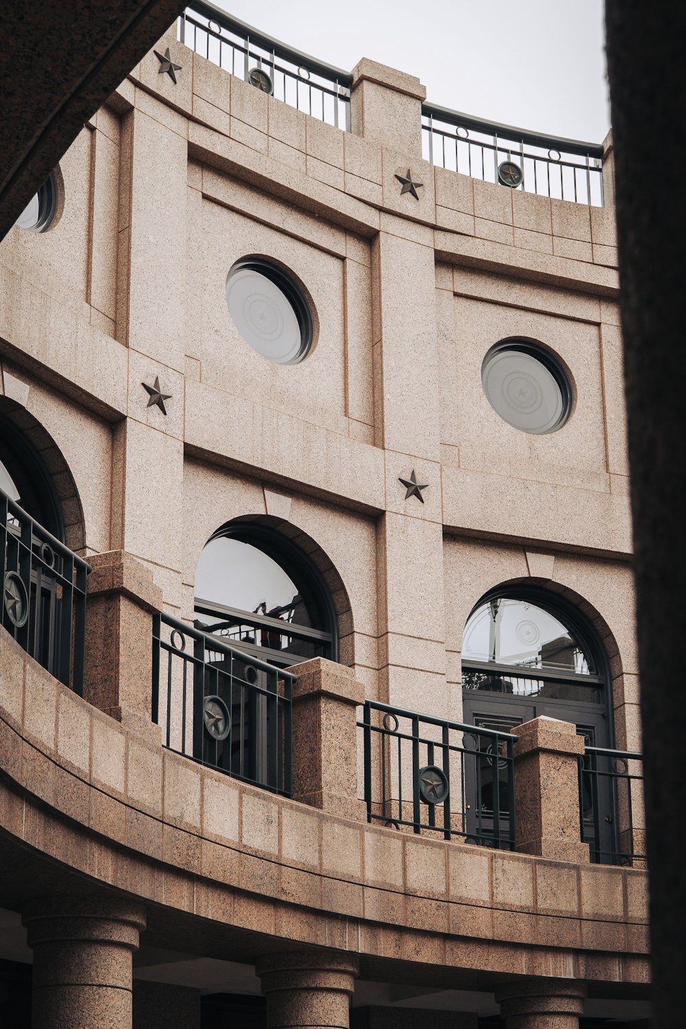 a building with a balcony and a clock on it