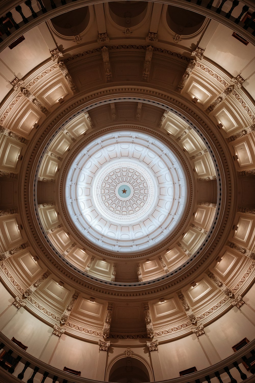 the ceiling of a building with a circular window