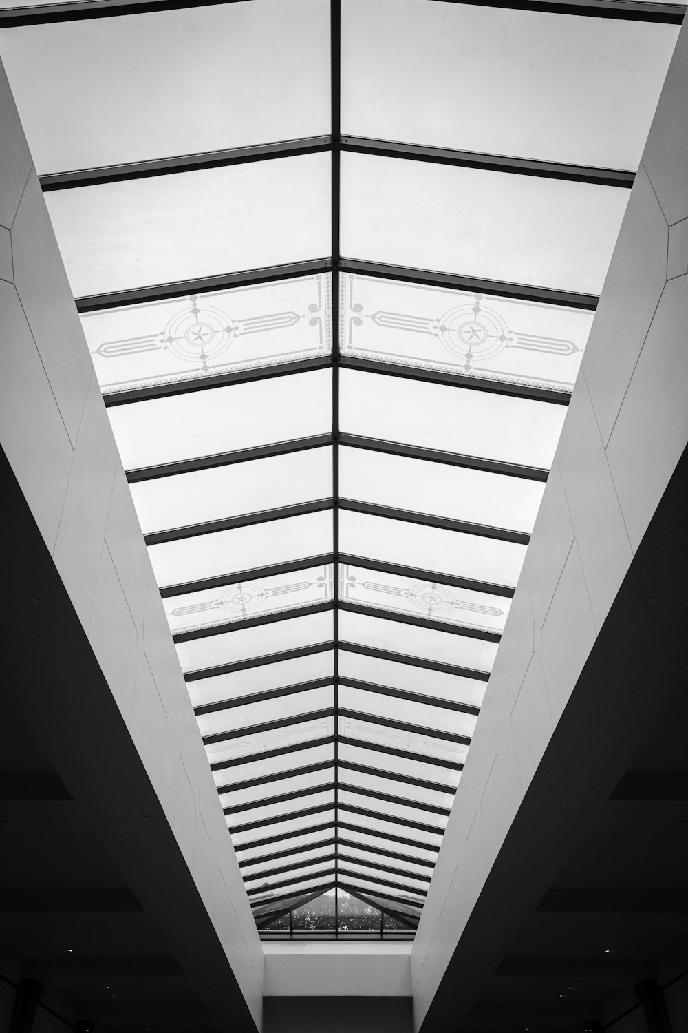 a black and white photo of a long hallway