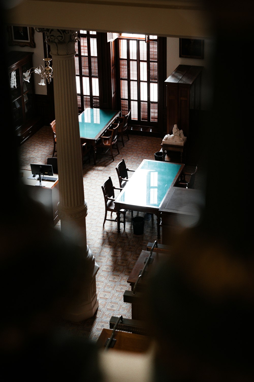 a room with a table, chairs, and a clock