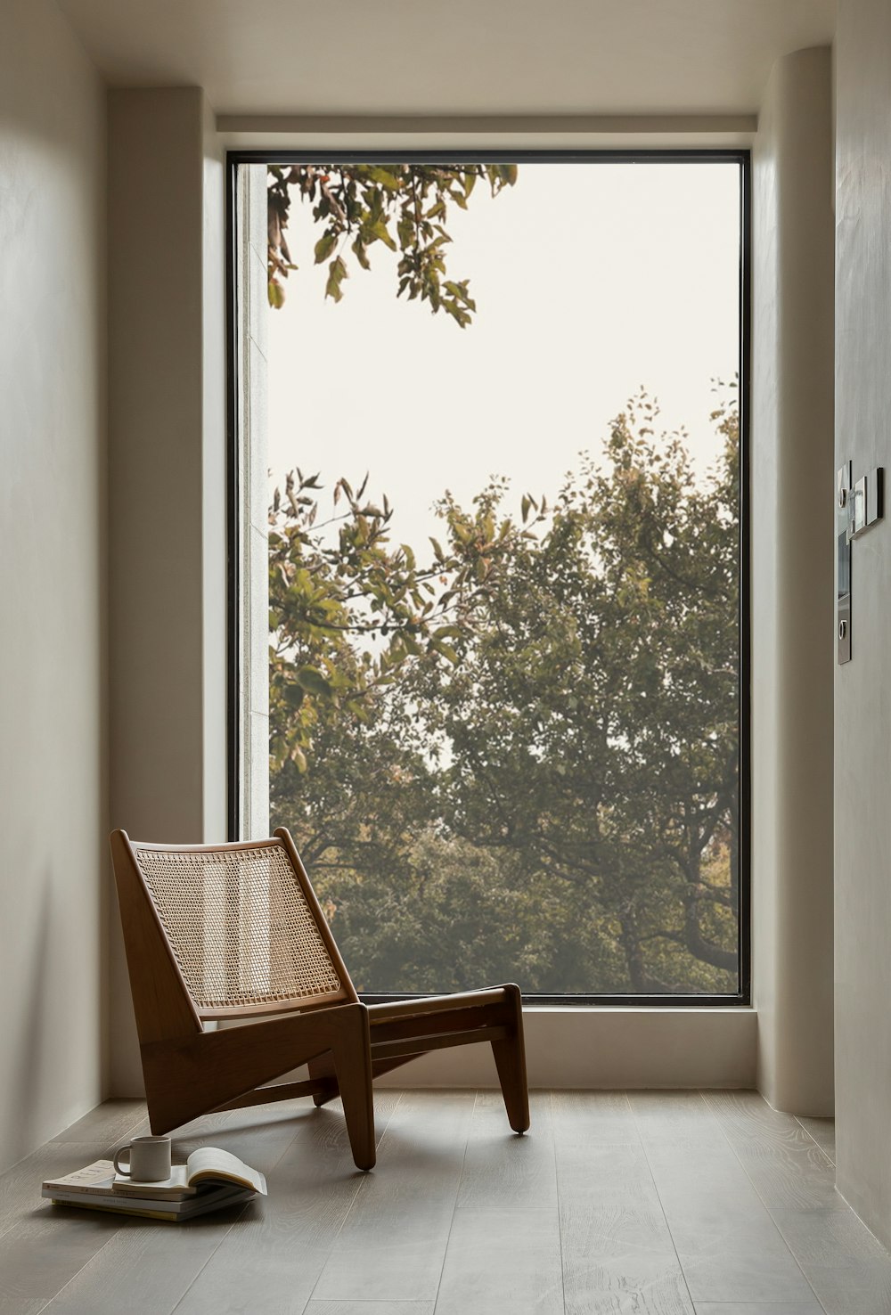 a chair sitting in front of a large window