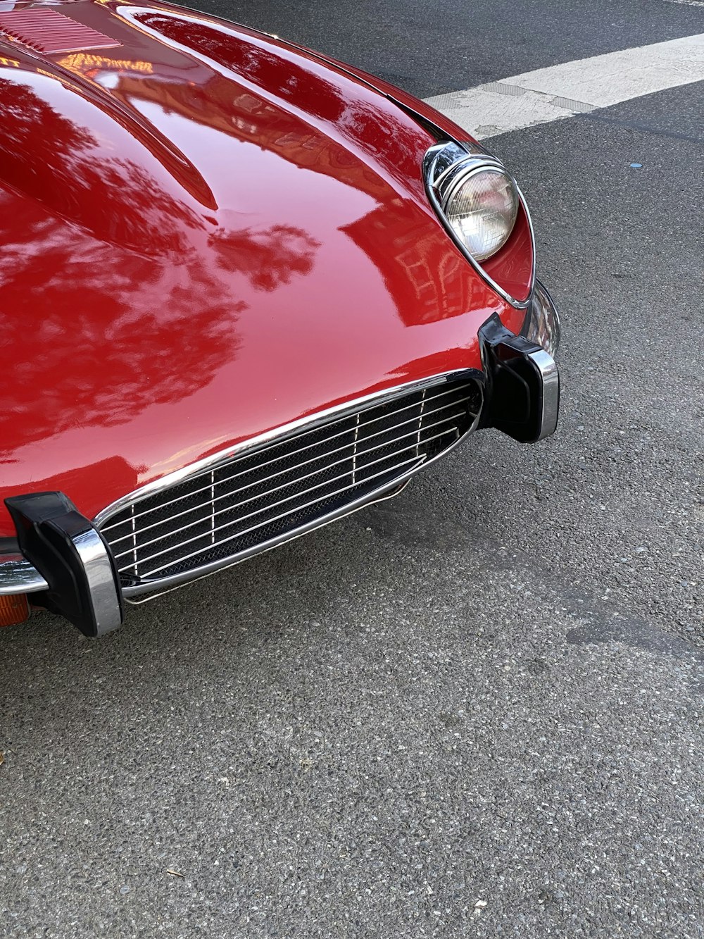 a close up of the front of a red sports car