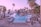 A serene tropical resort setting with tall palm trees surrounding a large, inviting swimming pool. The pool area is equipped with numerous white loungers and umbrellas, and a thatched-roof hut can be seen in the distance. The ocean is visible beyond the pool, and the sky is painted with soft hues of pink and purple, suggesting either sunrise or sunset.