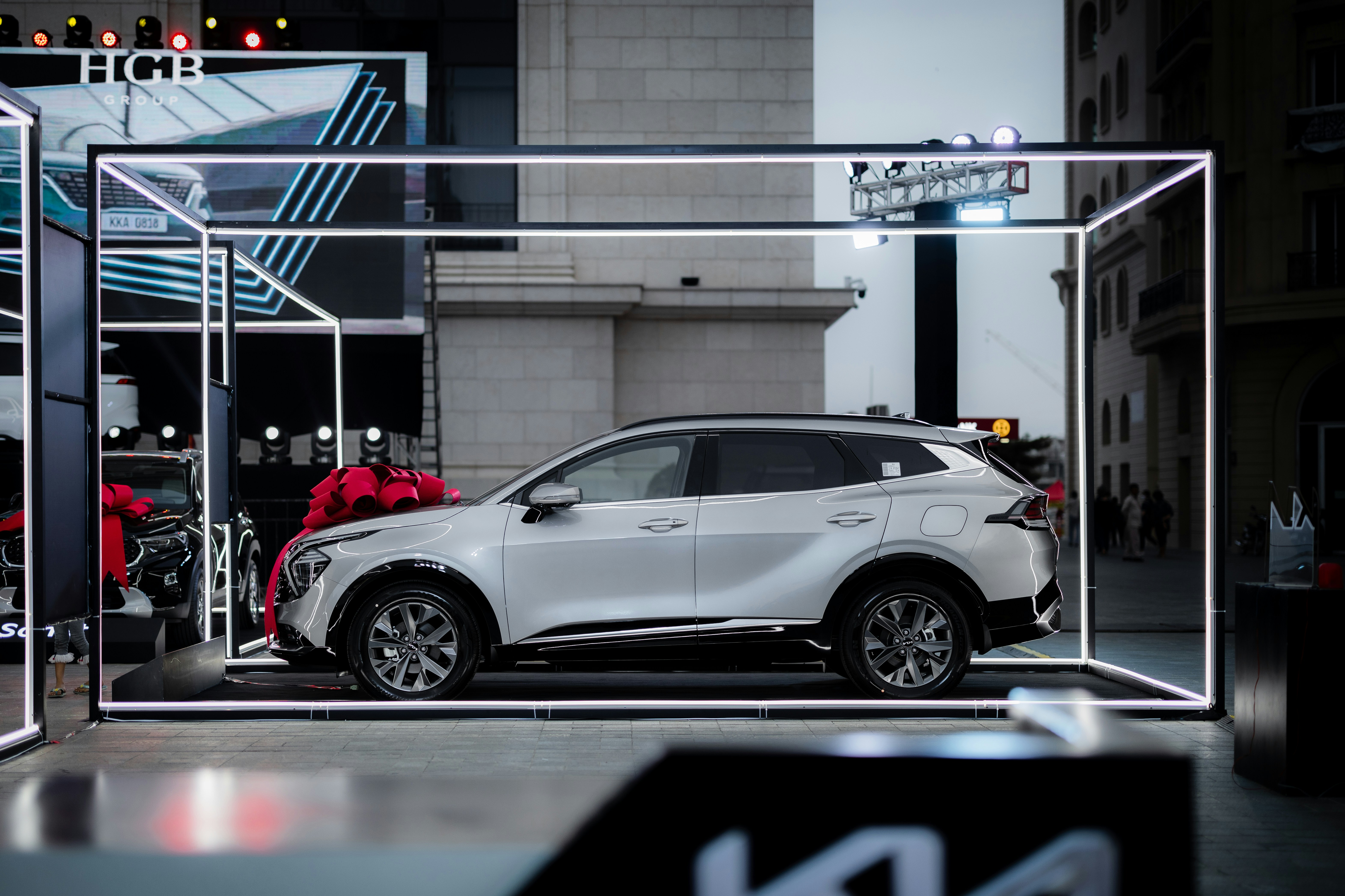 EV SUV dealership bestseller display - a white car is parked in a display case