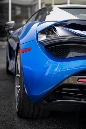 High-definition image of a sleek blue sports car emphasizing technological design.