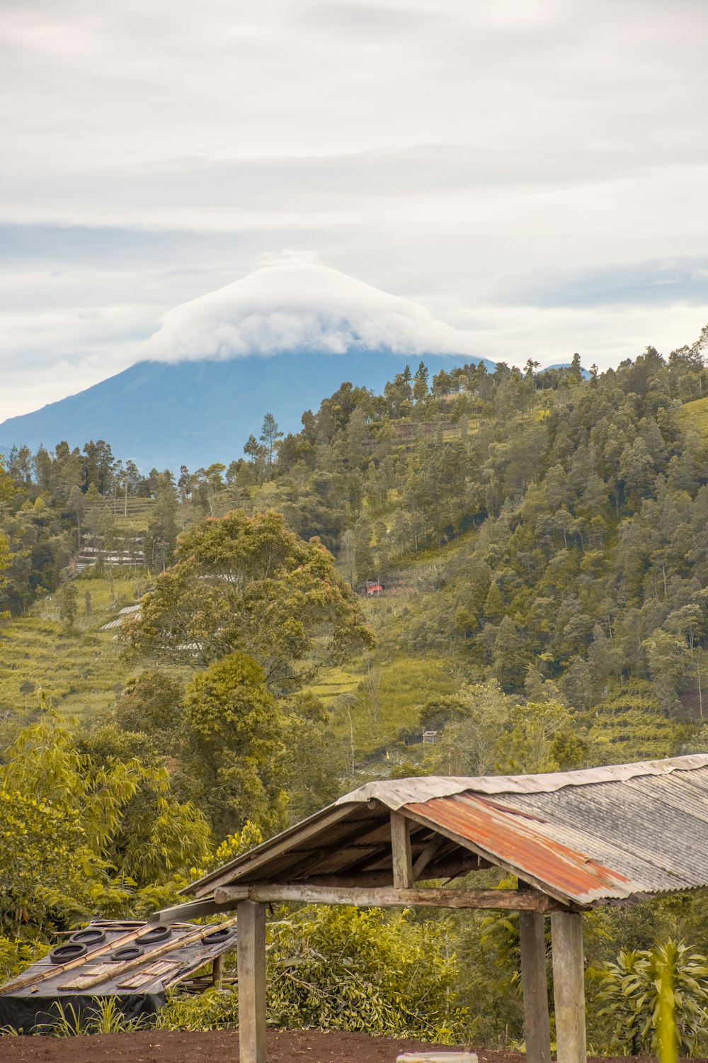 a view of a mountain range with a wooden shelter