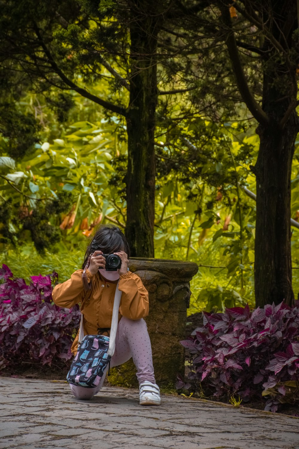 a young girl taking a picture of herself with a camera