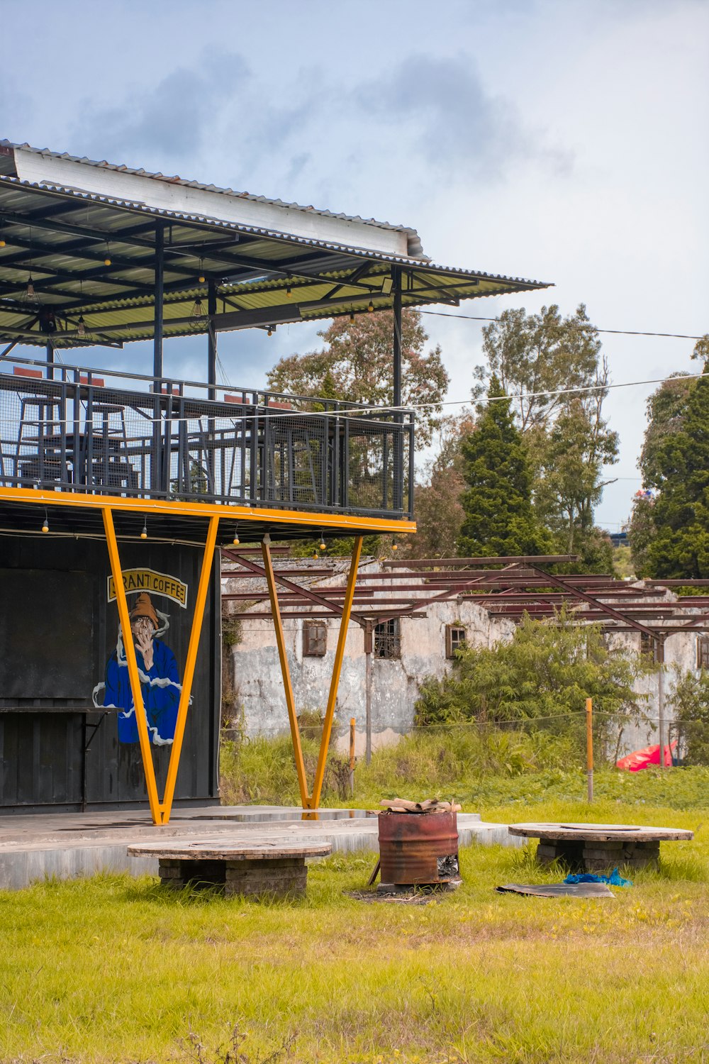 a building with a metal roof and a picnic table