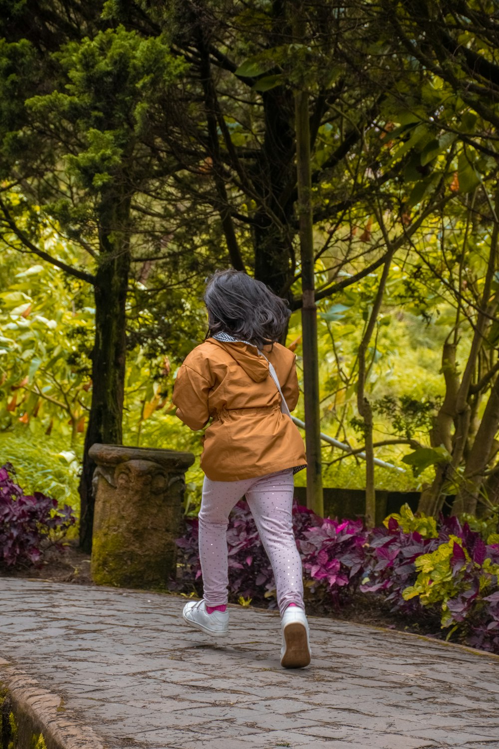 a little girl that is standing in the dirt