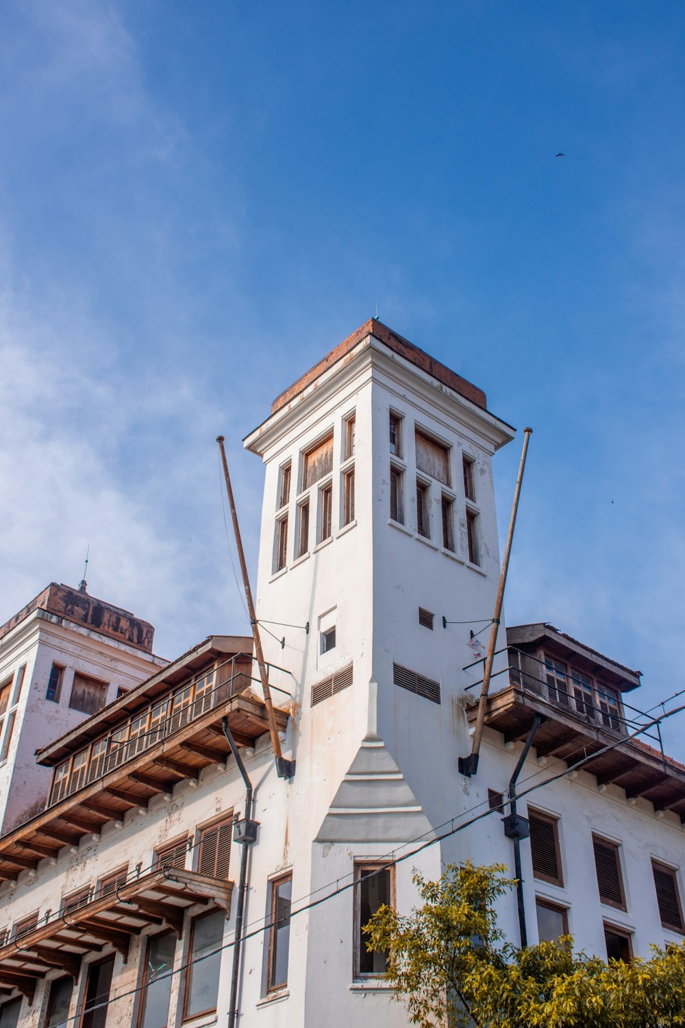 a tall white building with a clock on it's side