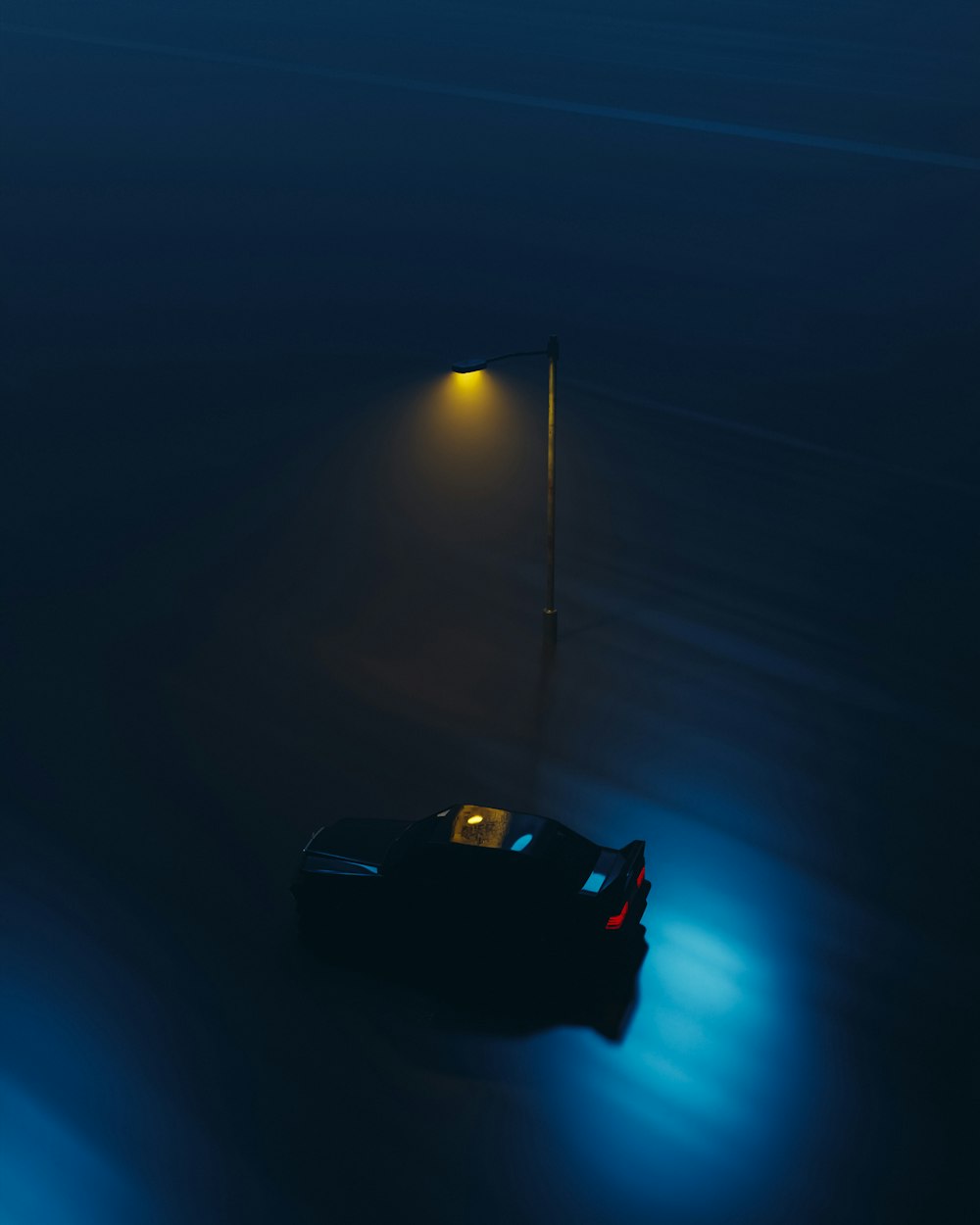 a car parked in the middle of a dark street