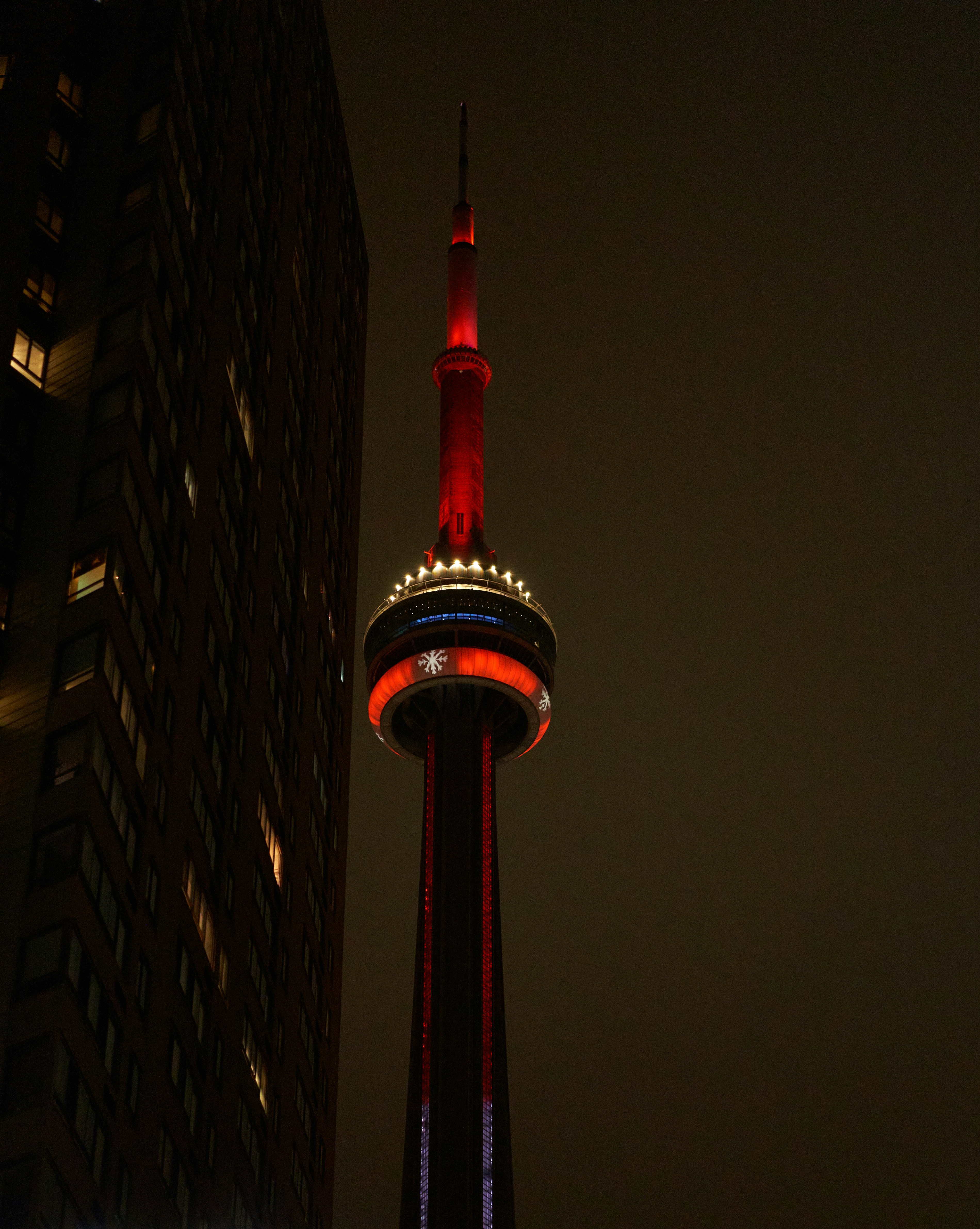 a tall building with a red light on top of it