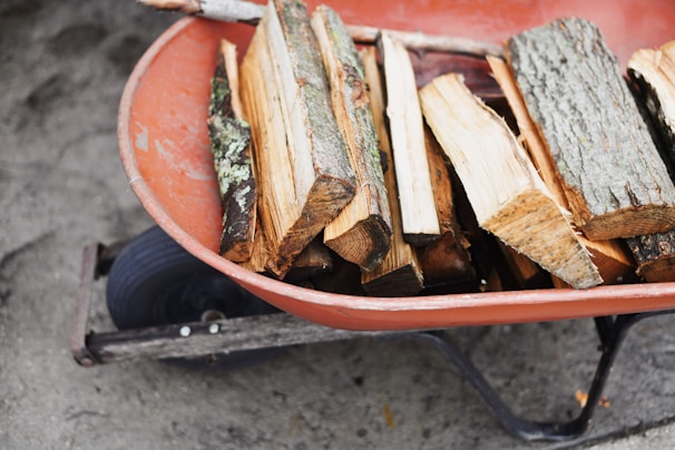 Heavy-duty wheelbarrow loaded with construction materials, positioned on rough terrain.