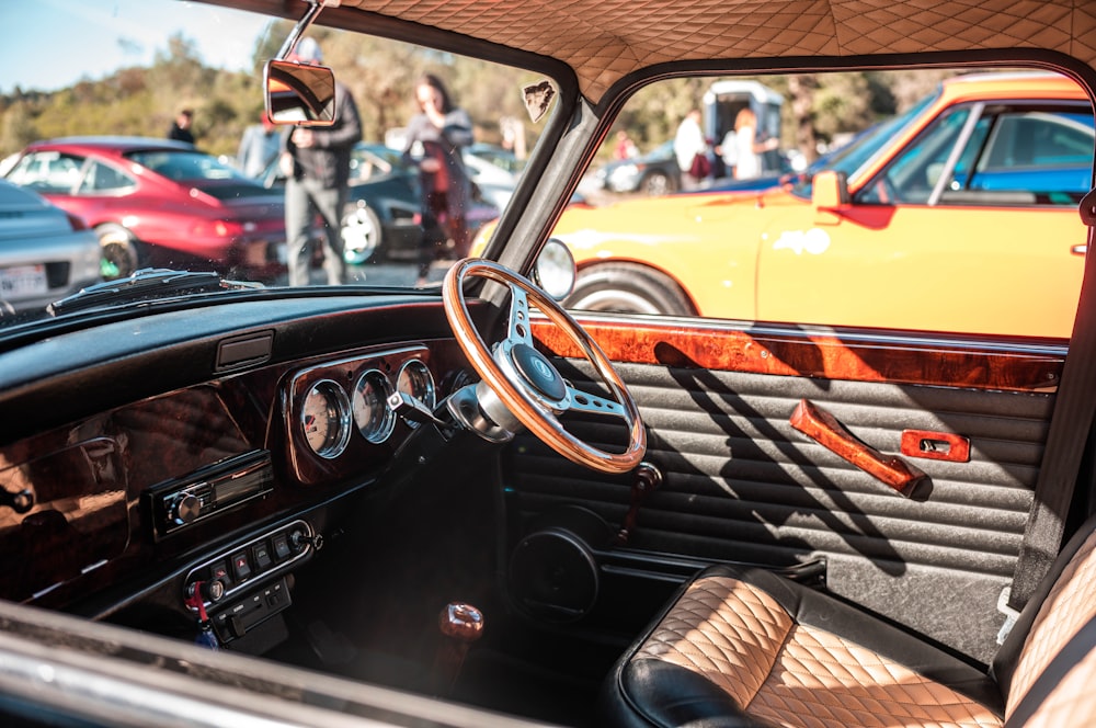 the interior of an old car with a lot of other cars in the background