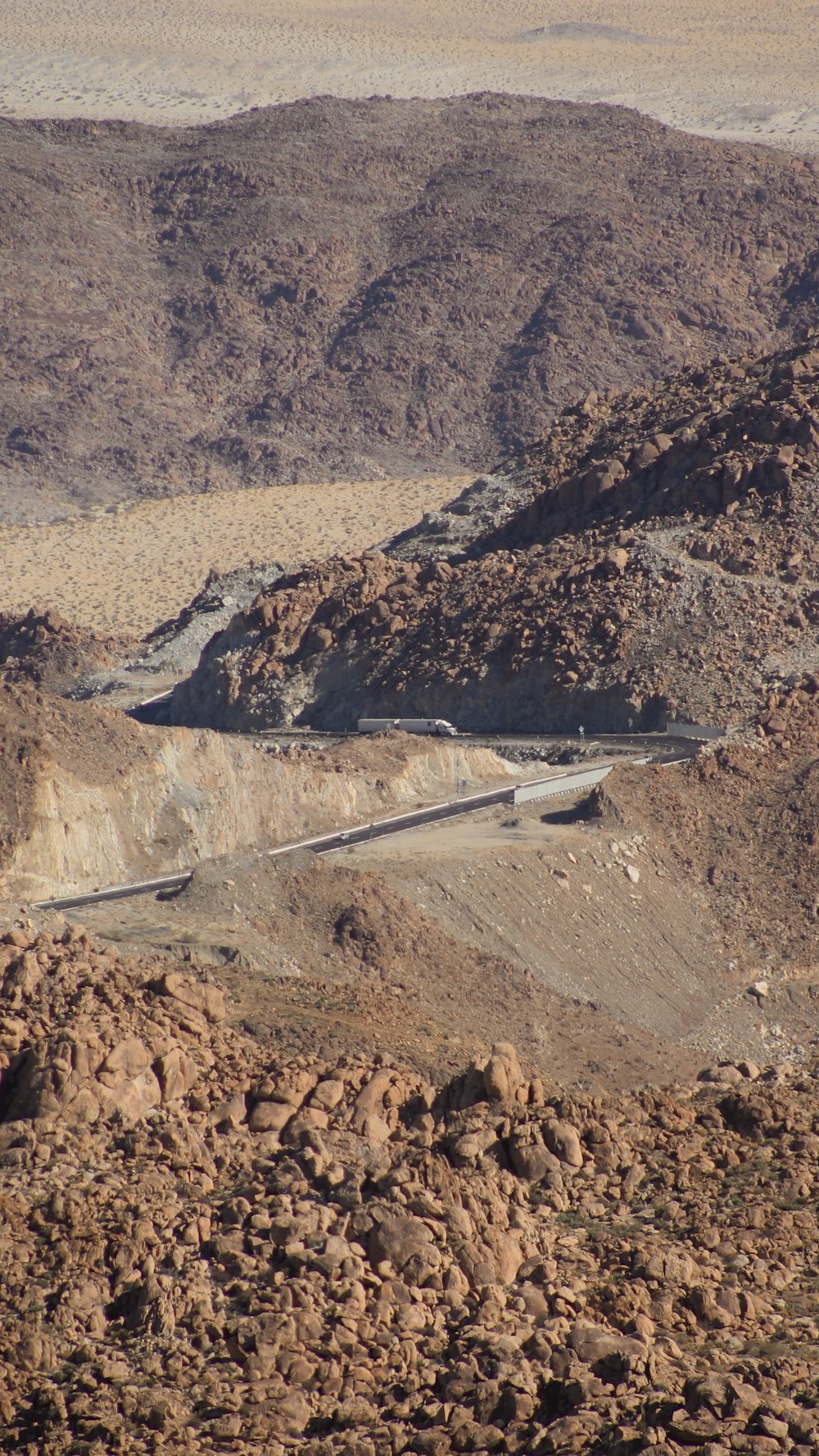 a winding road in the middle of a desert