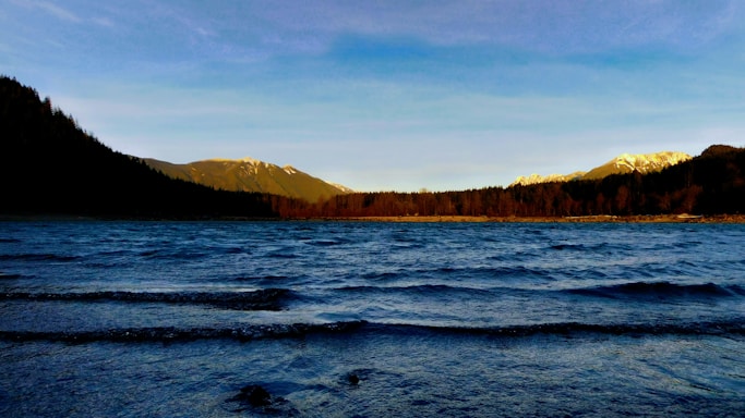 A serene view of the Adirondack mountains under a clear blue sky.