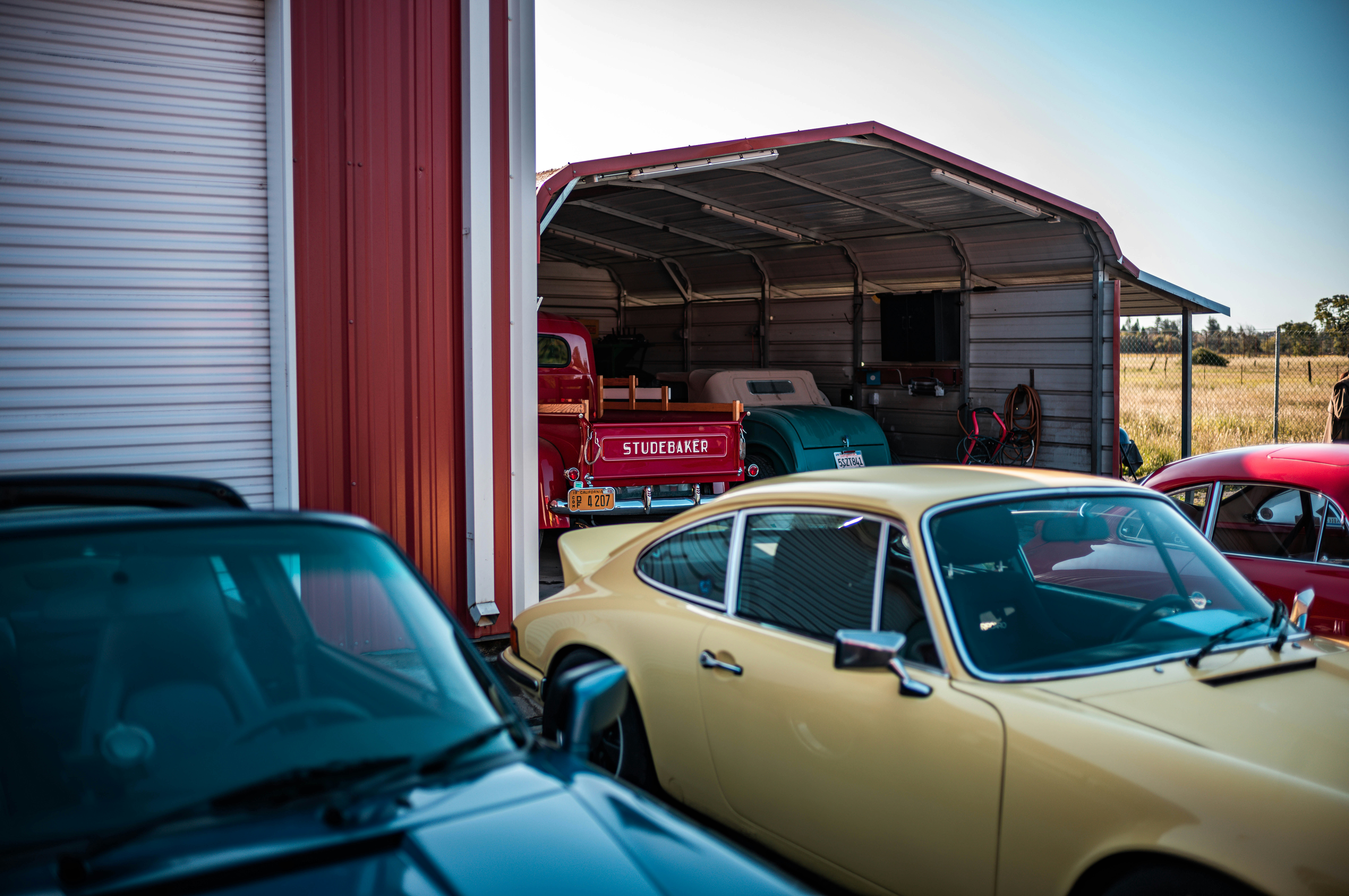 a group of cars parked in front of a garage