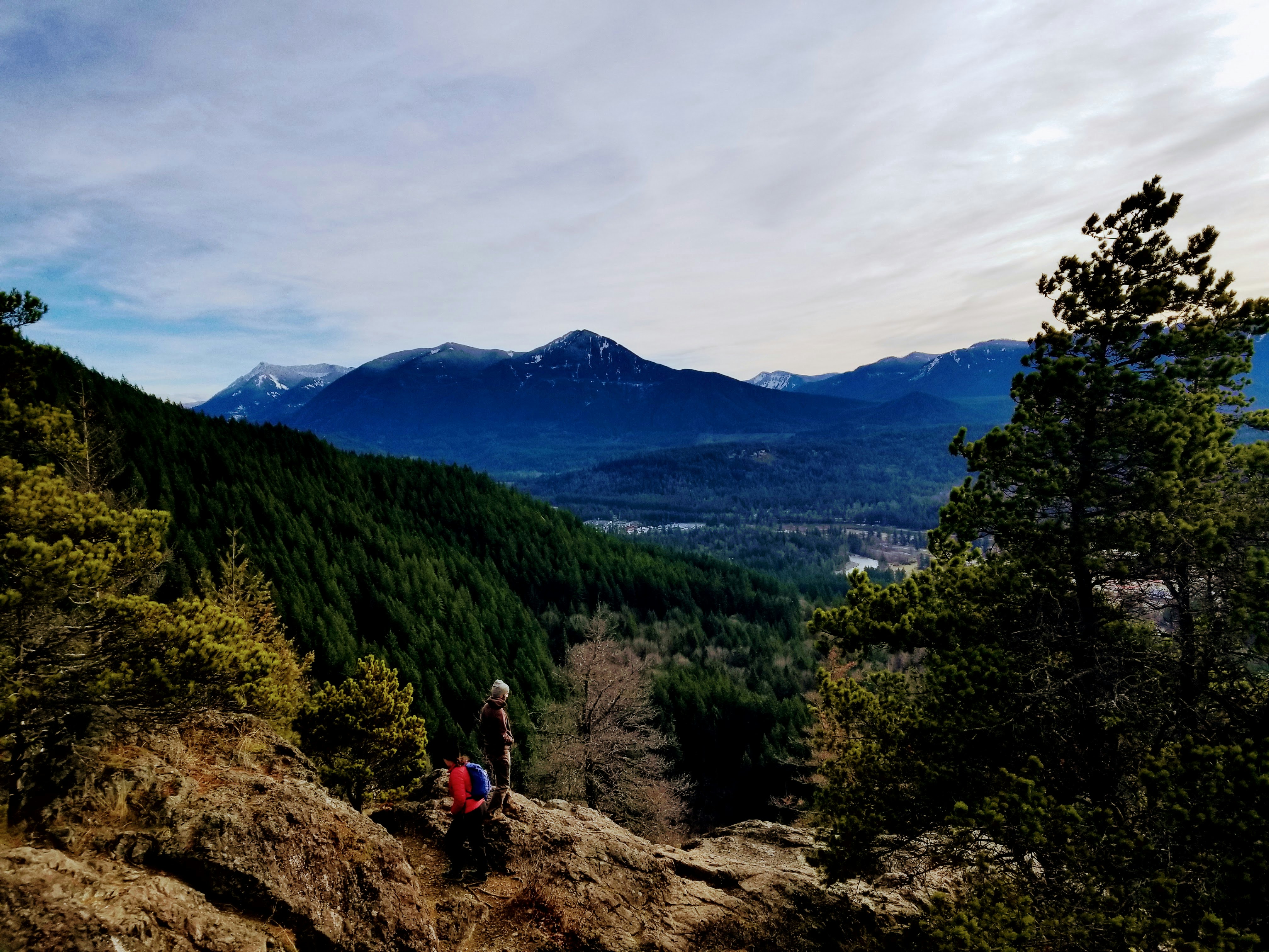 A couple of people sitting on top of a mountain photo – Free Forest ...