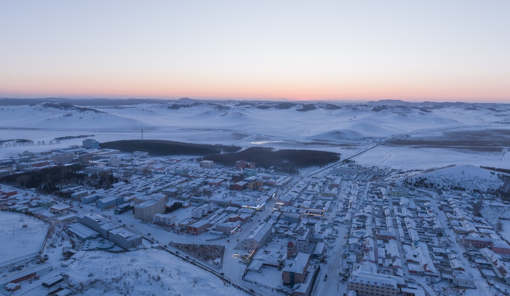 an aerial view of a city in the snow