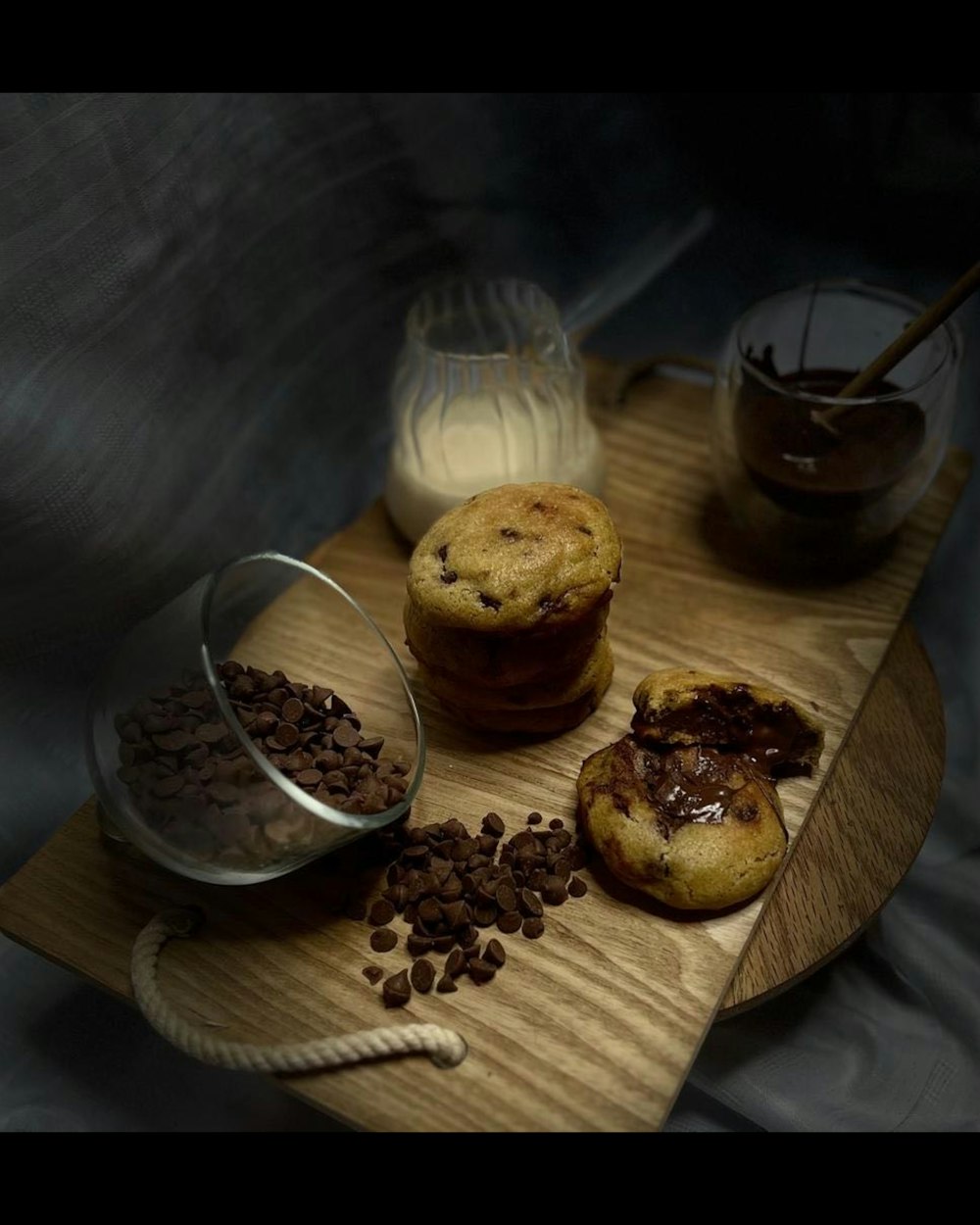 a wooden tray topped with muffins and chocolate chips