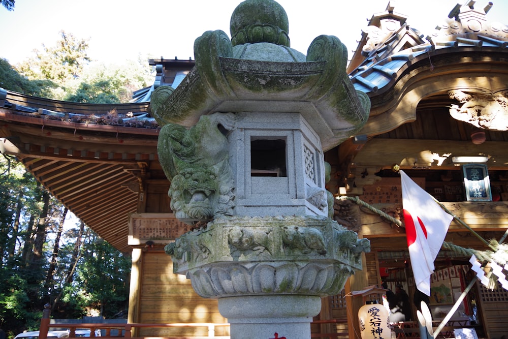 a stone lantern in front of a building