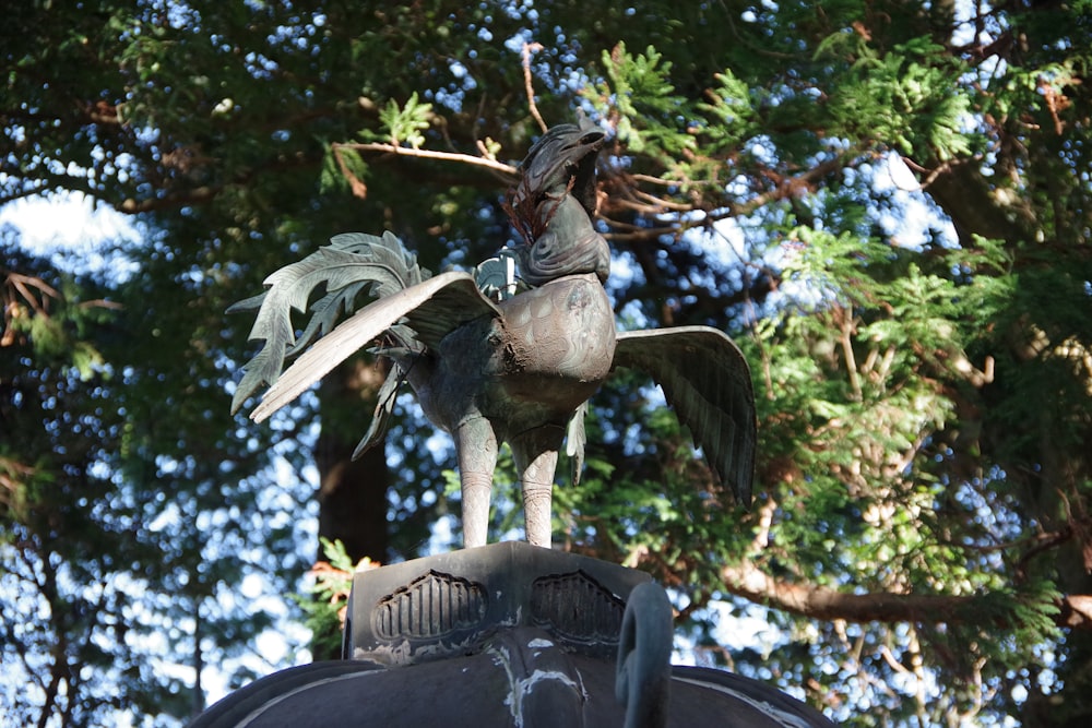 a statue of a bird on top of a building